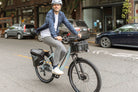 Person riding RadKick Arctic Blue electric bike in urban setting