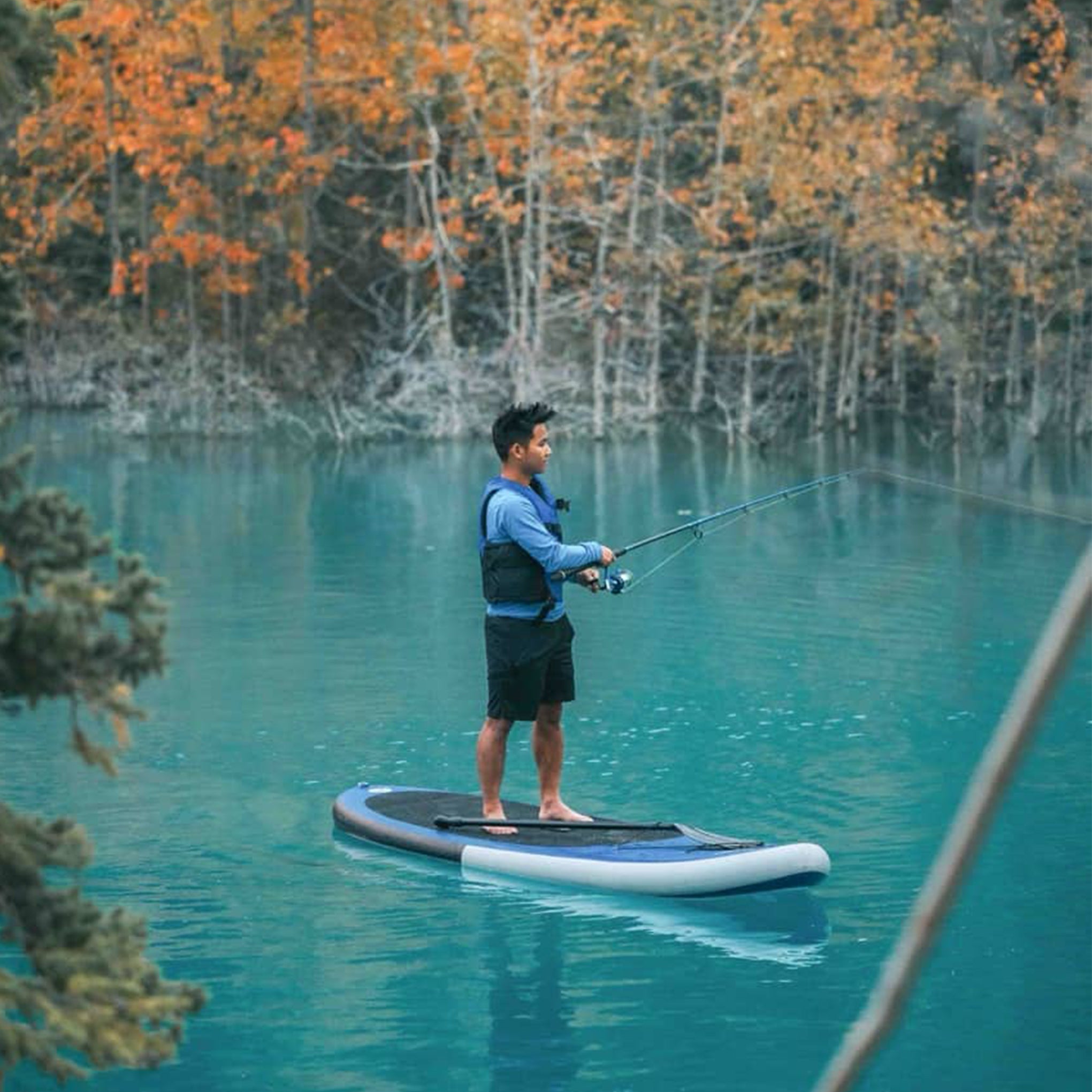 Synergy fishing paddleboard on a blue autumn lake